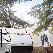 2019 Venture RV Sonic Lite SL169VMK Travel Trailer with Couple Hiking in Nature