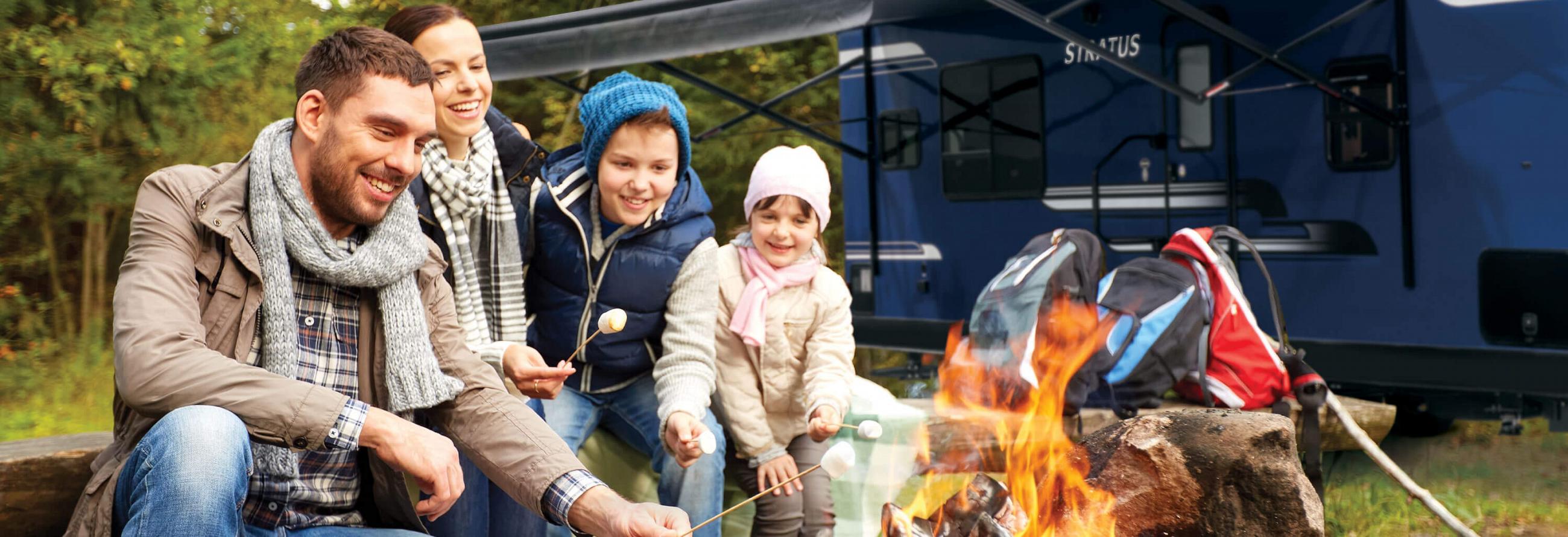 2019 Venture RV Stratus Travel Trailer with Family sitting around Campfire