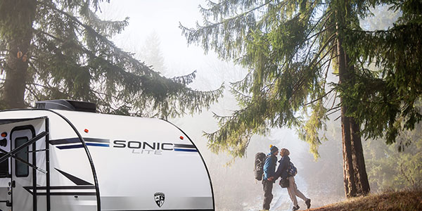 2019 Venture RV Sonic Lite SL169VMK Travel Trailer with Couple Hiking in Nature