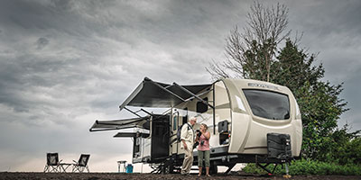 2020 Venture RV SportTrek Touring Edition STT343VIK Travel Trailer Exterior with couple preparing equipment
