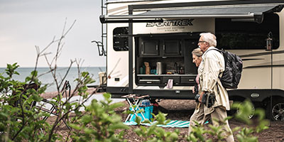 2020 Venture RV SportTrek Touring Edition STT343VIK Travel Trailer Exterior with couple leaving campsite for walk