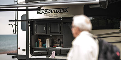 2020 Venture RV SportTrek Touring Edition STT343VIK Travel Trailer Exterior with man walking by kitchen