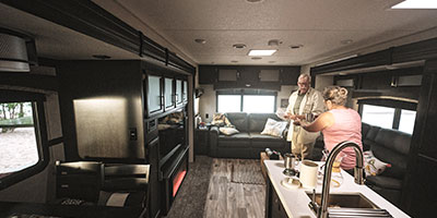 2020 Venture RV SportTrek Touring Edition STT343VIK Travel Trailer with man and woman in kitchen