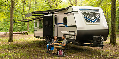 2019 Venture RV SportTrek ST327VIK Travel Trailer with couple at campsite