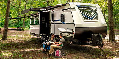 2019 Venture RV SportTrek ST327VIK Travel Trailer with couple at campsite