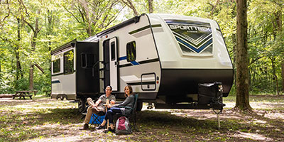 2020 Venture RV SportTrek ST327VIK Travel Trailer with couple at campsite