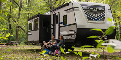 2019 Venture RV SportTrek ST327VIK Travel Trailer with couple at campsite