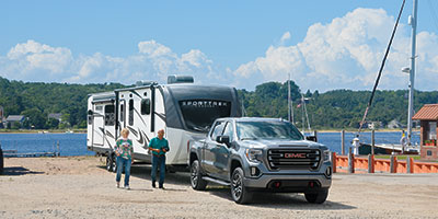 2023 Venture RV SportTrek Touring Edition STT343VIK Travel Trailer Lifestyle Couple at Boat Dock Walking
