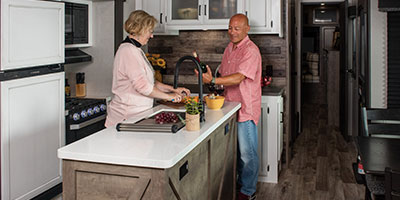 2023 Venture RV SportTrek Touring Edition STT343VIK Travel Trailer Lifestyle Couple in Kitchen