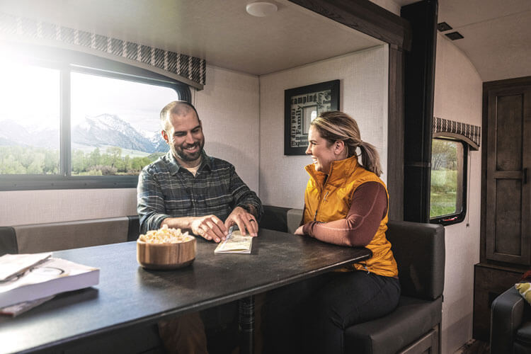 2023 Venture RV Sonic X SN220VRBX Travel Trailer with Couple at Dinette