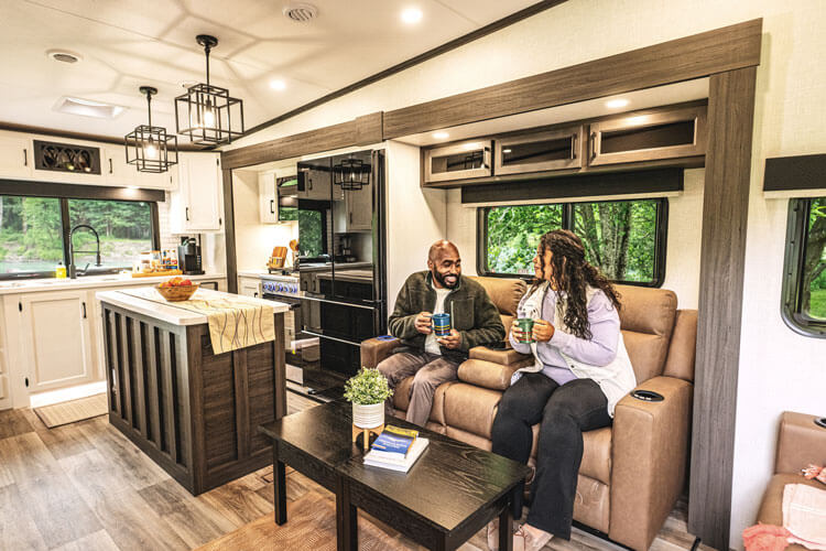 2026 Venture RV SportTrek Touring Edition STTF353VRK Fifth Wheel with Couple Relaxing on Theater Seating