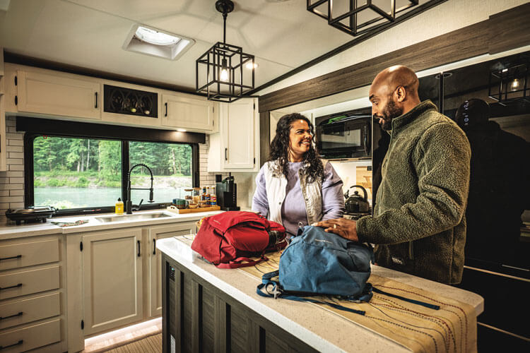 2026 Venture RV SportTrek Touring Edition STTF353VRK Fifth Wheel with Couple in Kitchen