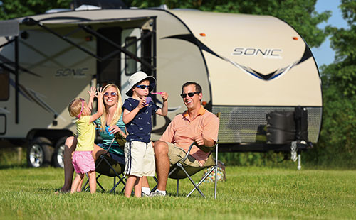 Family camping and playing with bubbles while enjoying their 2016 Sonic SN234VBH Travel Trailer - Close