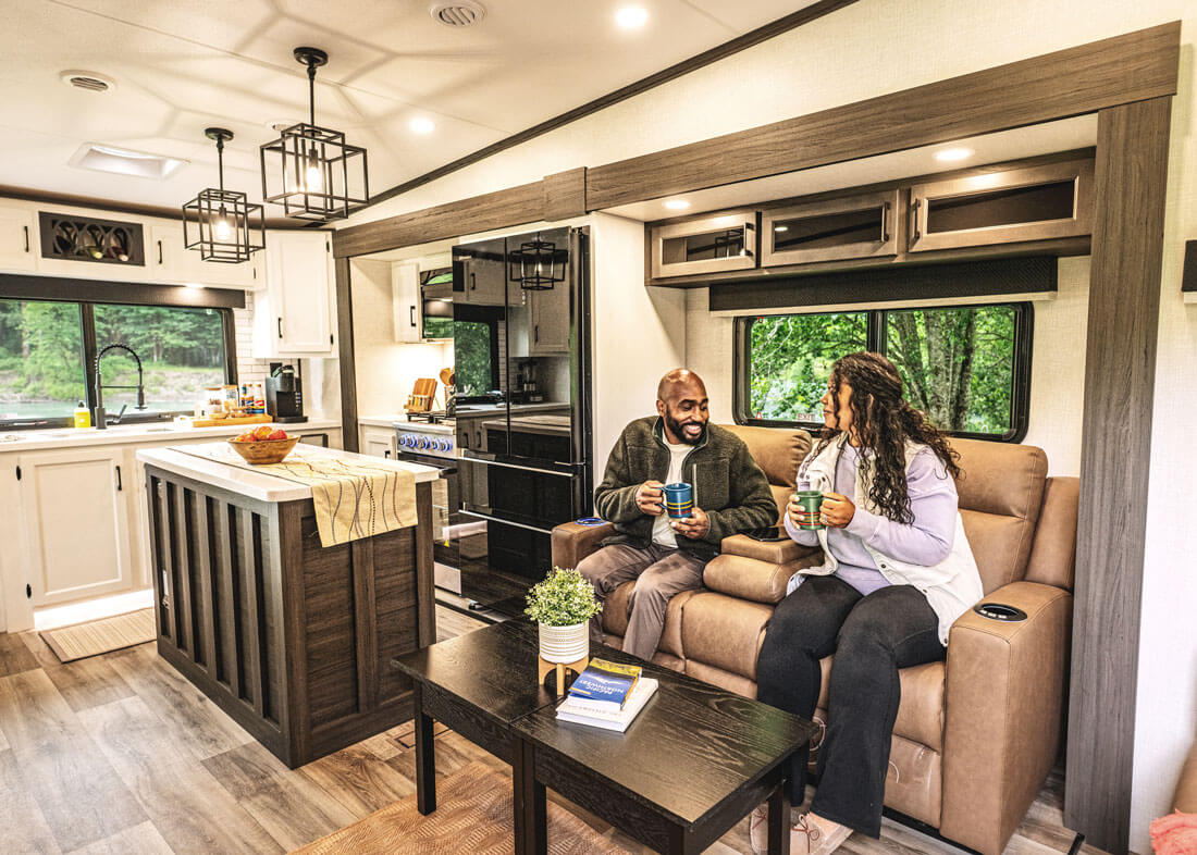 2026 Venture RV SportTrek Touring Edition Luxury Fifth Wheel with Couple Relaxing on Theater Seating